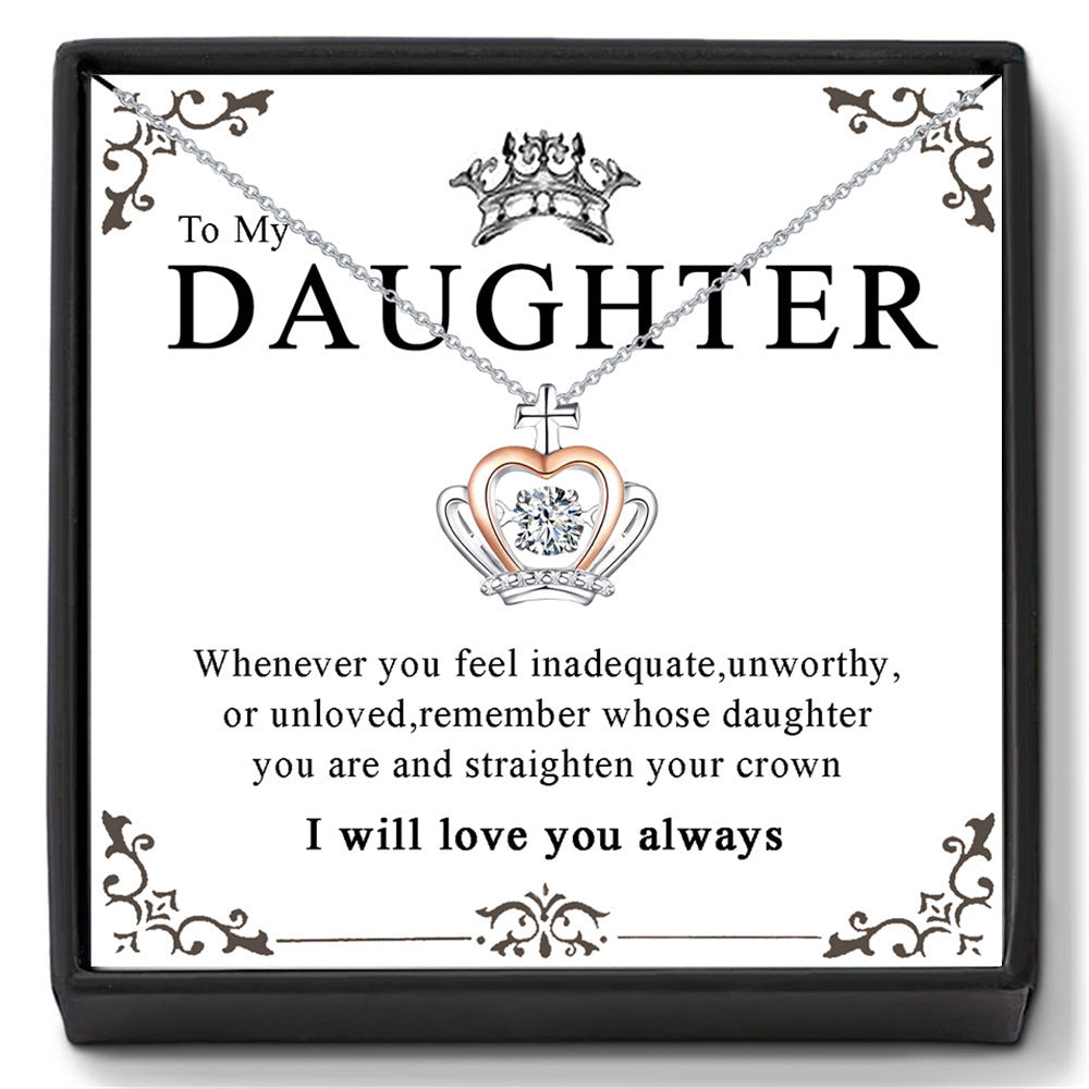 A necklace with a pendant featuring a crown and the inscription 'To My Daughter' with a chain and a heart-shaped pendant.