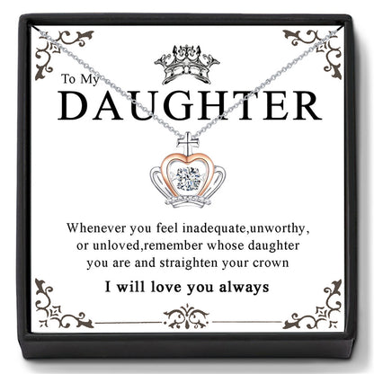 A necklace with a pendant featuring a crown and the inscription 'To My Daughter' with a chain and a heart-shaped pendant.